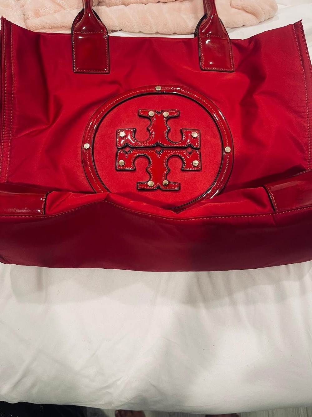 vibrant red Tory Burch Ella nylon tote bag with patent leather trim and a large